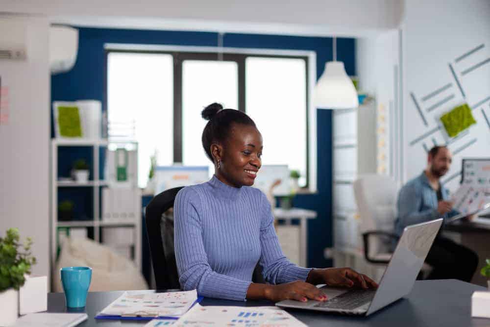 african woman working typing laptop computer concentrated finish important deadline